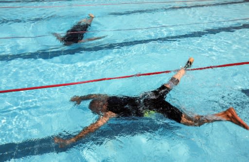 Iraqis who lost limbs during the government offensive against the Islamic State group swim during a special event in Arbil, the capital of Iraqi Kurdistan, on September 1, 2018