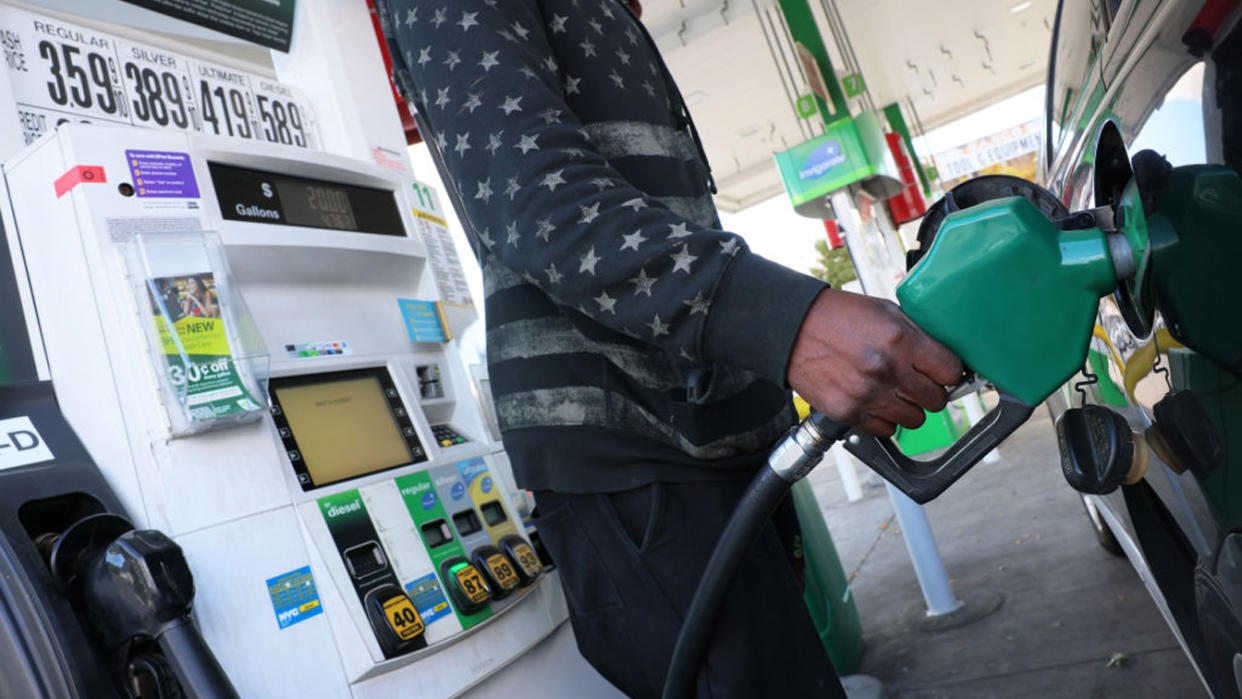 A person prepares to pump gas 