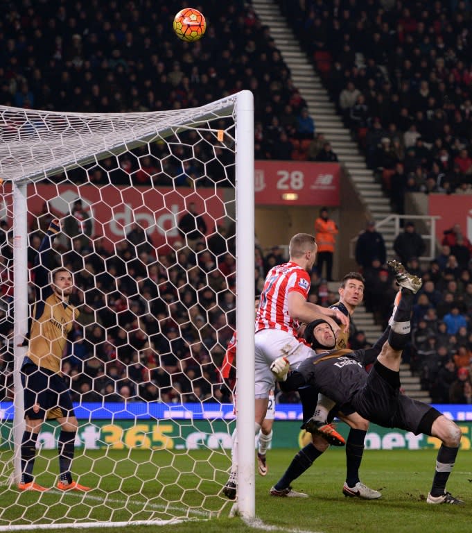 Arsenal's Petr Cech (R) competes with Stoke City's Ryan Shawcross (C) at the Britannia Stadium England on January 17, 2016