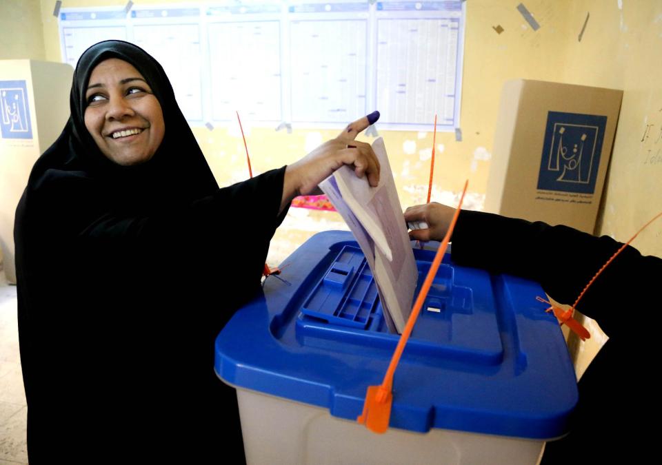 An Iraqi woman casts her vote inside a polling station for parliamentary elections in Baghdad, Iraq, Wednesday, April 30, 2014. Iraq is holding its third parliamentary elections since the U.S.-led invasion that toppled dictator Saddam Hussein. More than 22 million voters are eligible to cast their ballots to choose 328 lawmakers out of more than 9,000 candidates. (AP Photo/Karim Kadim)