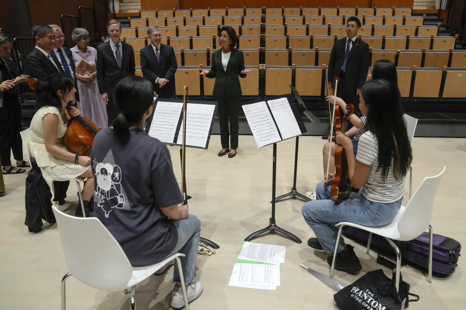 U.S. Commerce Secretary Gina Raimondo, center, meets with students during a visit to the New York University Campus in Shanghai, China, Wednesday, Aug. 30, 2023. (AP Photo/Andy Wong, Pool)