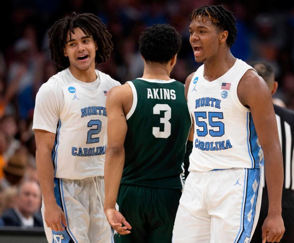 Michigan State’s Jaden Akins (3) is caught between the celebration of North Carolina’s Elliot Cadeau (2) and Harrison Ingram (55) after Ingram sank a three-point basket to secure a 69-57 lead in the second half on Saturday, March 23, 2024 in the second round of the NCAA Tournament at Spectrum Center in Charlotte, N.C.