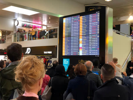 Stranded passengers look at the departures board at Gatwick Airport, Britain, December 20, 2018 in this picture obtained from social media. Ani Kochiashvili/via REUTERS