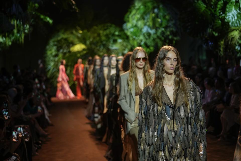 Models wear creations as part of the Roberto Cavalli women's Spring Summer 2024 collection presented in Milan, Italy, Wednesday, Sept. 20, 2023. (AP Photo/Luca Bruno)