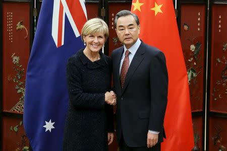 Australian Foreign Minister Julie Bishop (L) shakes hands with Chinese Foreign Minister Wang Yi as she arrives for a meeting at the Ministry of Foreign Affairs in Beijing, China, 17 February 2016. REUTERS/Wu Hong/Pool