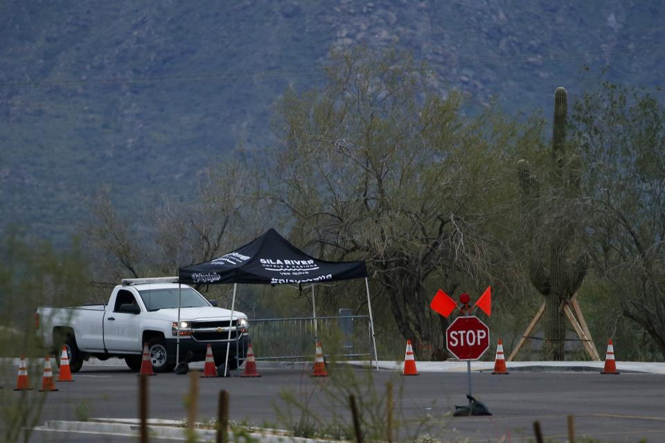 A security checkpoint at the entrance to the Gila River Hotels & Casinos Vee Quiva location shows the property is closed due to the coronavirus Friday, March 20, 2020, in Laveen, Ariz. Native American tribes across the U.S. have been closing their properties, with all casinos in the Phoenix metro area closing down. (AP Photo/Ross D. Franklin)