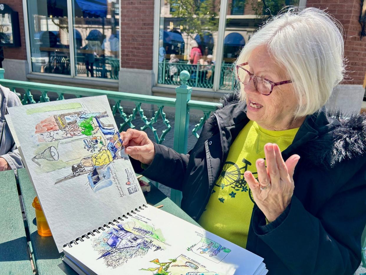 Donna Bogle shows her work during a recent Urban Sketchers West Michigan gathering held last Thursday.