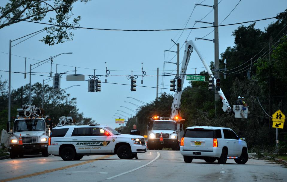 Sarasota County Sheriff's Office deputies block Proctor Rd. at Riverwood Ave. in Sarasota, as power crews work to restore electricity on Thursday morning, Sept. 29, 2022 following Hurricane Ian.