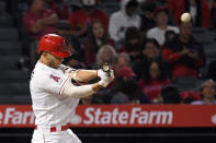 Los Angeles Angels' Andrelton Simmons, right, hits a two-run home run during the fourth inning of a baseball game against the Houston Astros Saturday, Sept. 28, 2019, in Anaheim, Calif. (AP Photo/Mark J. Terrill)