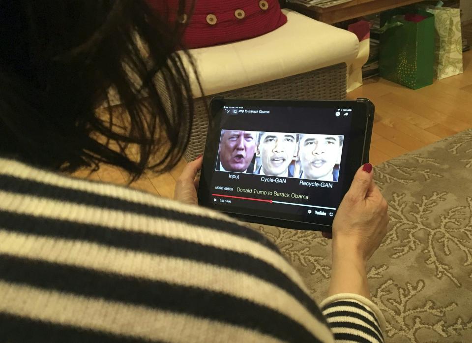 A woman in Washington, DC, views a manipulated video on January 24, 2019, that changes what is said by President Donald Trump and former president Barack Obama, illustrating how deepfake technology can deceive viewers. - "Deepfake" videos that manipulate reality are becoming more sophisticated and realistic as a result of advances in artificial intelligence, creating a potential for new kinds of misinformation with devastating consequences. (Photo by Rob Lever / AFP) / TO GO WITH AFP STORY by Rob LEVER "Misinformation woes may multiply with deepfake videos"        (Photo credit should read ROB LEVER/AFP via Getty Images)