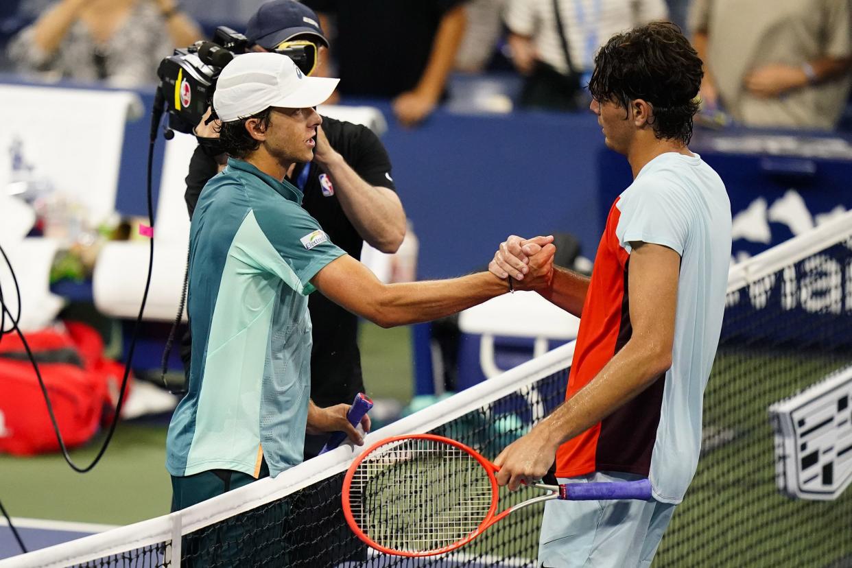 Brandon Holt, left, of the United States, shakes hands with Taylor Fritz, of the United States, after defeating him during the first round of the U.S. Open tennis championship on Monday, Aug. 29, 2022, in New York.