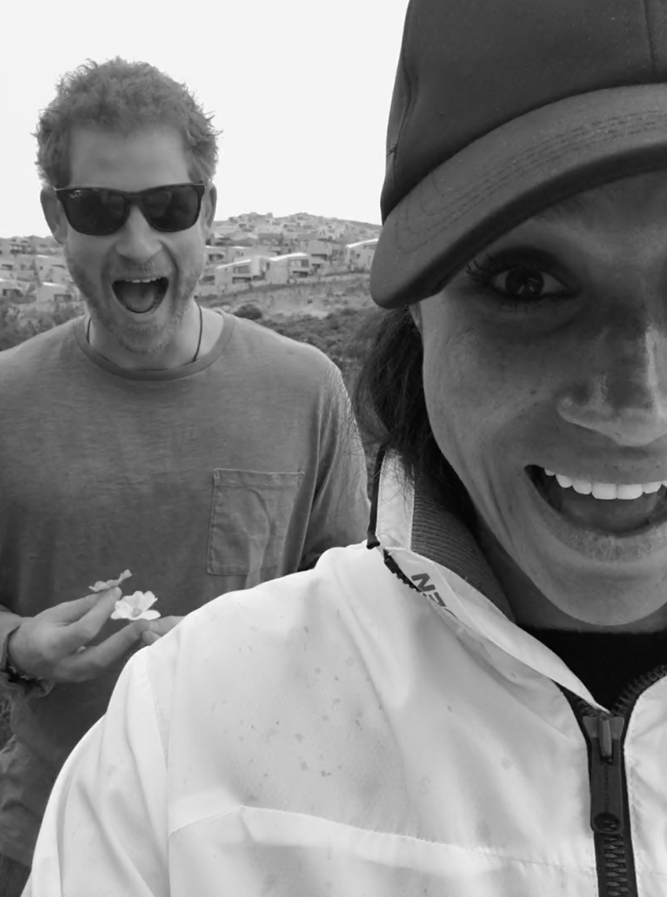 Meghan takes a selfie with Harry, and he pulls a face.