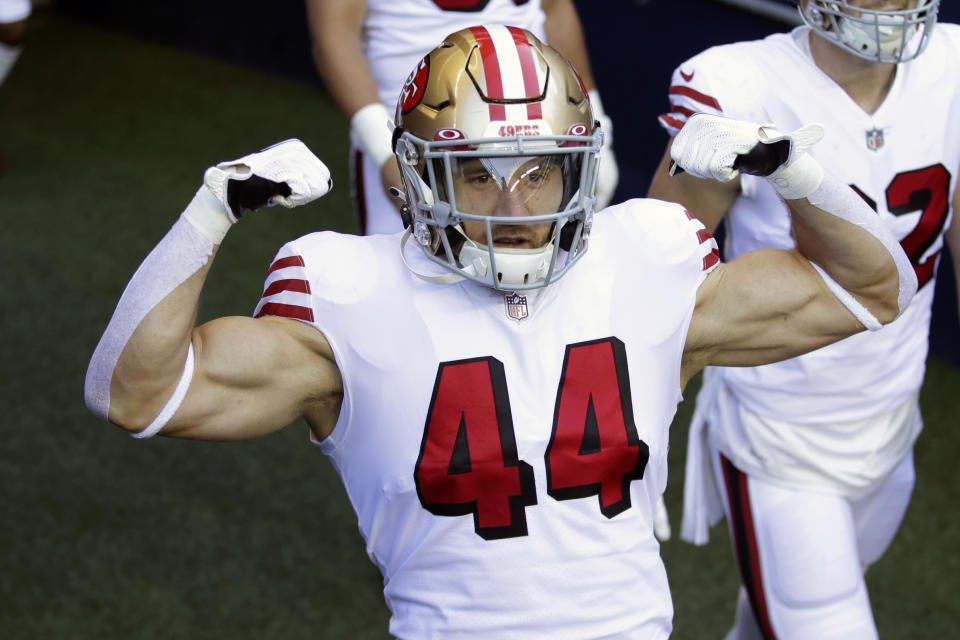 San Francisco 49ers fullback Kyle Juszczyk flexes his muscles as he walks onto the field to warm up before an NFL football game against the Seattle Seahawks, in Seattle. Late Sunday, March 14, 2021, the San Francisco 49ers agreed on a five-year, $27 million contract with Juszczyk that will make him the highest paid fullback in the NFL. (AP Photo/Scott Eklund, File)