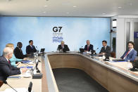 Britain's Prime Minister Boris Johnson, center, with from left, Australia's Prime Minister Scott Morrison, German Chancellor Angela Merkel, South Africa's President Cyril Ramaphosa, South Korea's President Moon Jae-in, US President Joe Biden, French President Emmanuel Macron and Canadian Prime Minister Justin Trudeau during the G7 summit in Cornwall, England, Saturday June 12, 2021. (Leon Neal/Pool via AP)