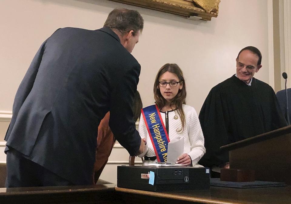 Lola Giannelli,  a fifth grader from Nashua, N.H., shakes hands with New Hampshire Gov. Chris Sununu on Jan. 18, 2019, at the Statehouse in Concord, N.H., after she was elected the state's first "Kid Governor" as part of civics program created by the Connecticut Democracy Center.