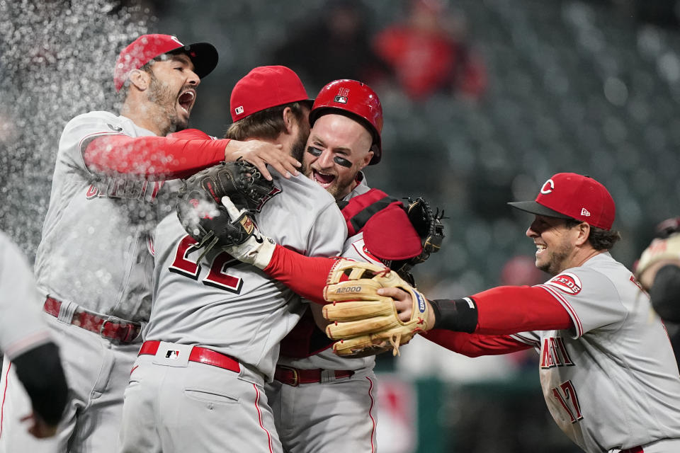 Cincinnati Reds teammates mob Wade Miley (22) after he pitched a no-hitter against the Cleveland Indians in a baseball game, Friday, May 7, 2021, in Cleveland. (AP Photo/Tony Dejak)