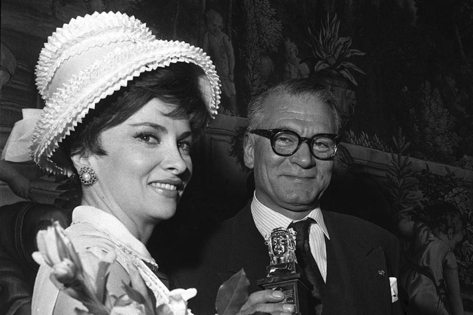 Gina Lollobrigida with Sir Laurence Olivier, in May 1963 (PA)