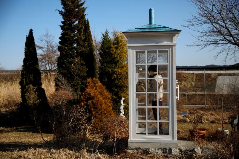 The Wider Image: Japan's tsunami survivors call lost loves on the phone of the wind