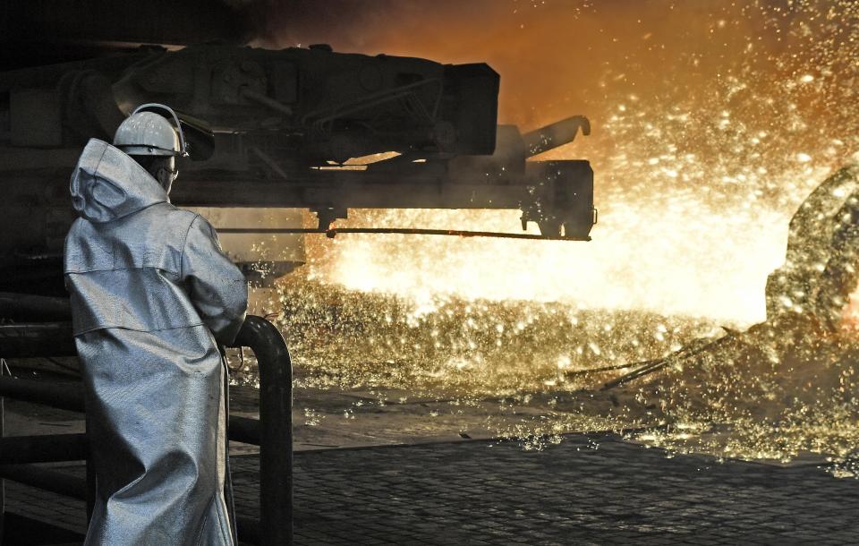 A steel worker watches the hot metal at the Thyssenkrupp steel factory in Duisburg, Germany, Friday, April 27, 2018. Duisburg is the biggest steel producer site in Europe. (AP Photo/Martin Meissner)