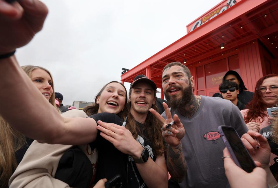 Fans take a selfie with Post Malone during the grand opening celebration of a Raising Cane’s Restaurant, designed by the singer, in Midvale on Thursday, April 13, 2023. | Kristin Murphy, Deseret News