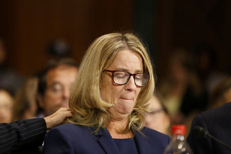 Christine Blasey Ford reacts as she speaks before the Senate Judiciary Committee hearing on the nomination of Brett Kavanaugh to be an associate justice of the Supreme Court of the United States, on Capitol Hill in Washington, DC, U.S., September 27, 2018. Michael Reynolds/Pool via REUTERS
