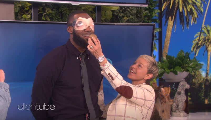 LeBron James completes a dare with Ellen DeGeneres involving a blindfold and kiwi during her show Wednesday, Sept. 12. James and Channing Tatum raised $100,000 for James’ I Promise School.