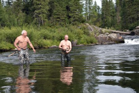 Russian President Vladimir Putin and head of the Republic of Khakassia Viktor Zimin fish during the hunting and fishing trip which took place on August 1-3 in the republic of Tyva in southern Siberia, Russia, in this photo released by the Kremlin on August 5, 2017. Sputnik/Alexei Nikolsky/Kremlin via REUTERS