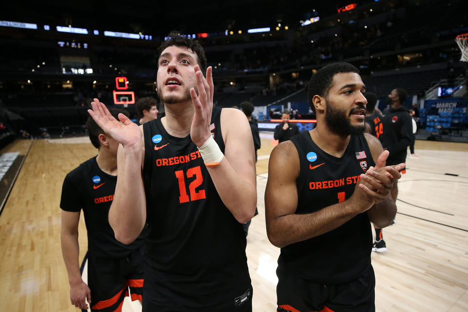 Roman Silva (12) and Maurice Calloo (1) of the Oregon State Beavers celebrate after defeating Loyola Chicago on March 27. (Jamie Squire/Getty Images)