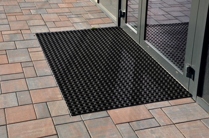 A floor mat at a store's entrance