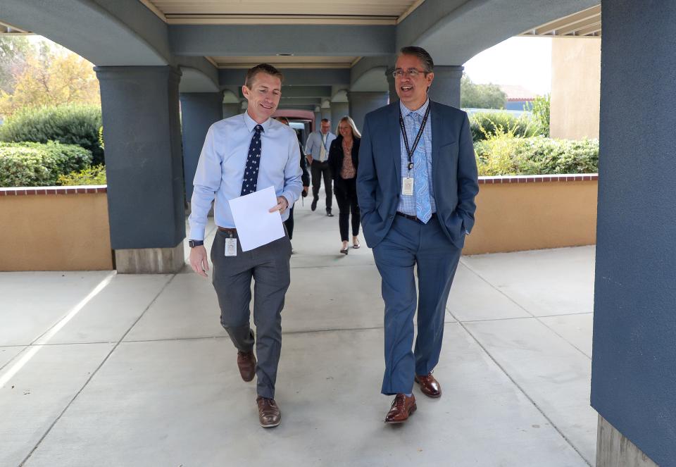 Palm Springs Unified School District superintendent Tony Signoret, right, walks the campus during a site visit with Rio Vista Elementary School principal Aaron Tarzian in Cathedral City, Calif., Dec. 12, 2023.