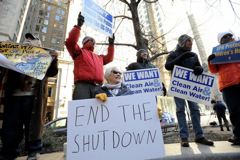 PHOTO: Protesters hold signs during a rally by government workers and concerned citizens against the government shutdown on Jan. 11, 2019, at Post Office Square near the headquarters for the EPA and IRS in Boston. (Joseph Prezioso/AFP via Getty Images, FILE)