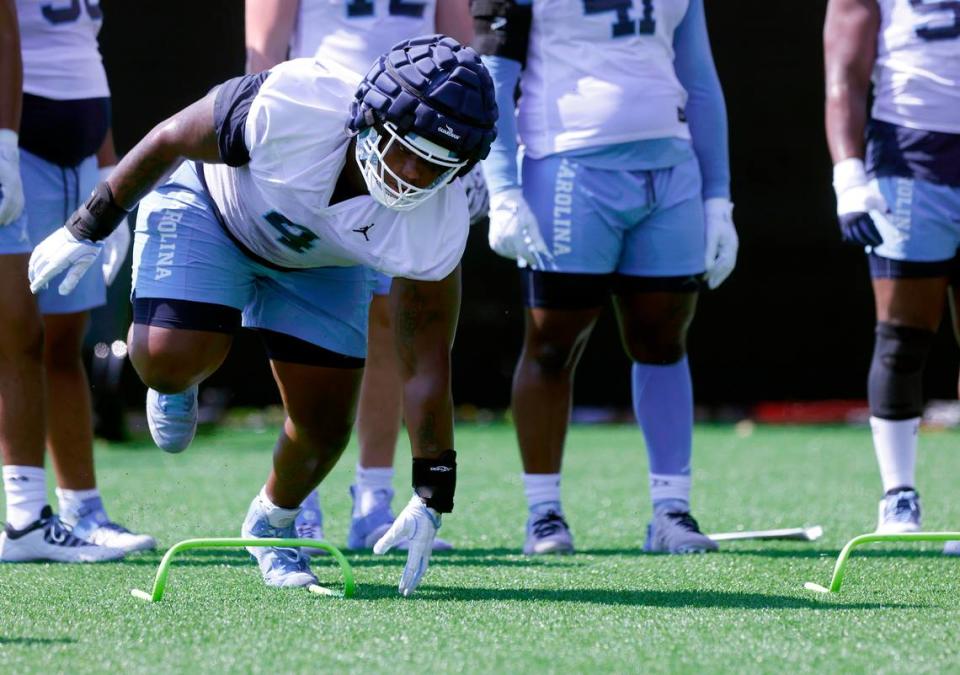 North Carolina defensive lineman Travis Shaw (4) runs a drill during UNC’s first football practice of the season on Friday, July 29, 2022, in Chapel Hill, N.C.