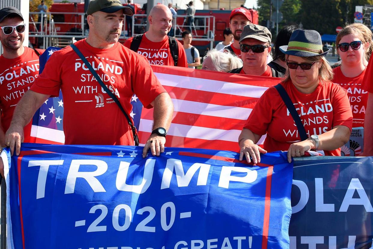 Supporters of US President Donald Trump hold banners as they attend commemorations marking 80 years since the outbreak of World War II on September 1, 2019 at Pilsudski Square in Warsaw, Poland: AFP/Getty Images