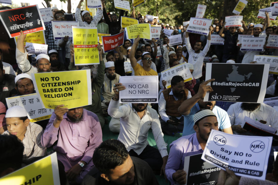 Indians holds placards and shouts slogans during a protest against Citizenship Amendment Act in Ahmadabad, India, Sunday, Dec. 15, 2019. Protests have been continuing over a new law that grants Indian citizenship based on religion and excludes Muslims. (AP Photo/Ajit Solanki)