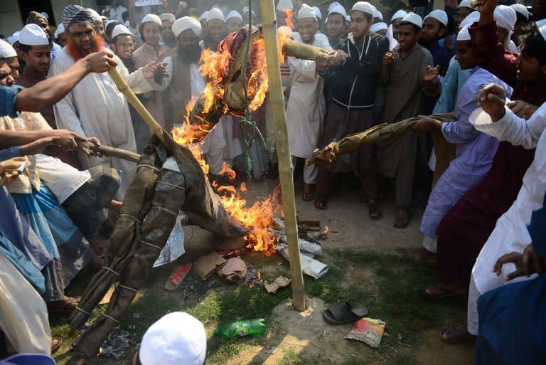 Supporters of Islamic political parties burn and kick an effigy of a blogger inside a madrassa, or religious school, during a nationwide strike in Dhaka on February 24, 2013. Islamists demanding the execution of bloggers they accuse of blasphemy clashed with police in Bangladesh for a third straight day Sunday, and at least four protesters were killed when police opened fire