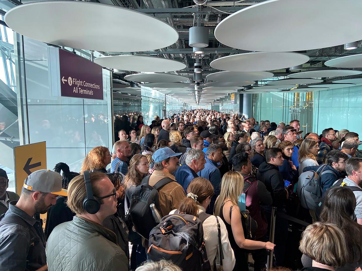 People queue at arrivals at Heathrow airport in London, Saturday, May 27, 2023 (AP)