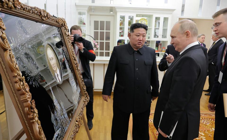 Kim Jong Un presents Putin with artwork of the Russian leader.