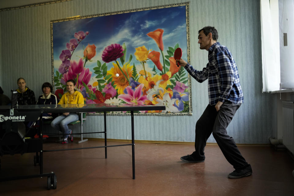 Residents play table tennis in a facility for people with mental and physical disabilities in the village of Tavriiske, Ukraine, Wednesday, May 11, 2022. The staff is faced with the dilemma of evacuating the facility, and how to do it with minimum disruption to the residents, some of whom have very severe disabilities and others for whom changes in environment can be disorientating and highly stressful. (AP Photo/Francisco Seco)