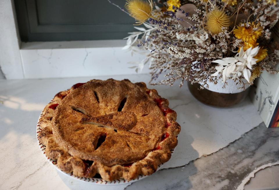 A cranberry pie, with double crust and a turkey leg design added to the top layer for decoration.