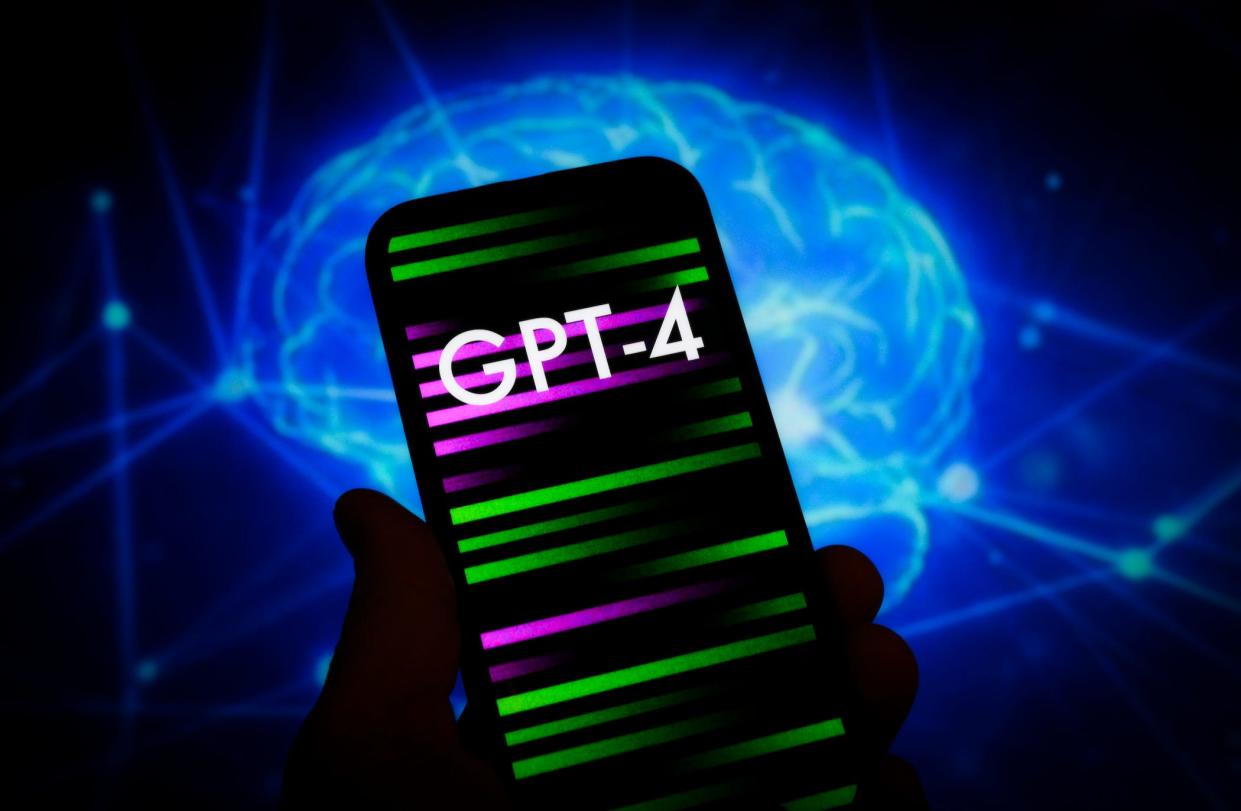 person holding phone with the word 'gpt-4' on it