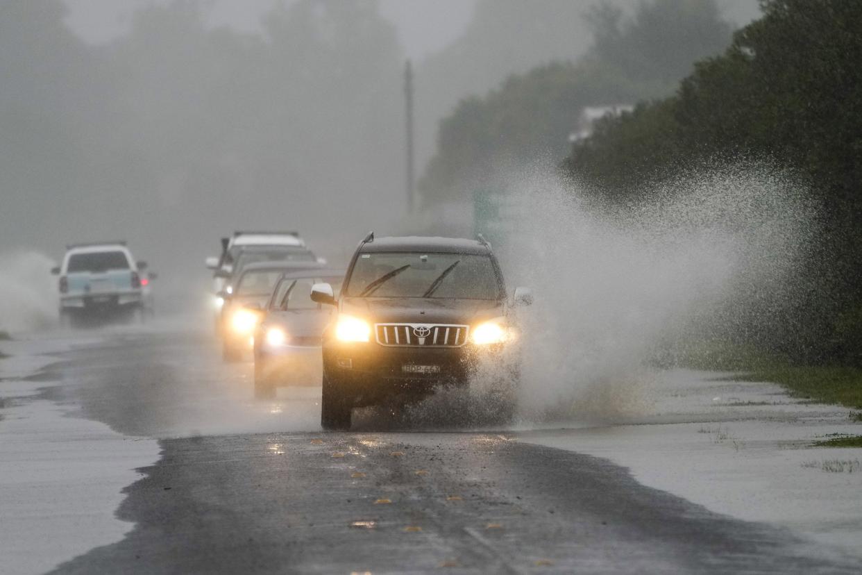 Cars drive through flood waters in Richmond on the outskirts of Sydney, Australia on Monday, July 4, 2022. More than 30,000 residents of Sydney and its surrounds have been told to evacuate or prepare to abandon their homes on Monday as Australia's largest city braces for what could be its worst flooding in 18 months.