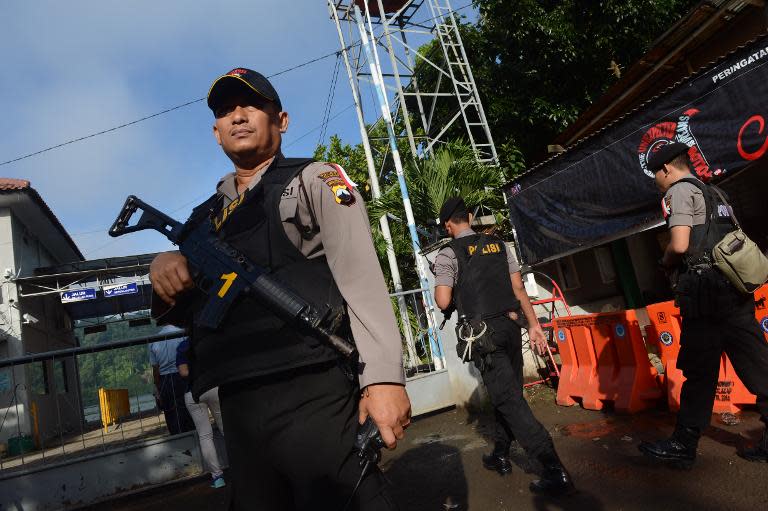 Police secure the Nusakambangan port in Cilacap located across from Nusakambangan maximum security prison island on April 28, 2015