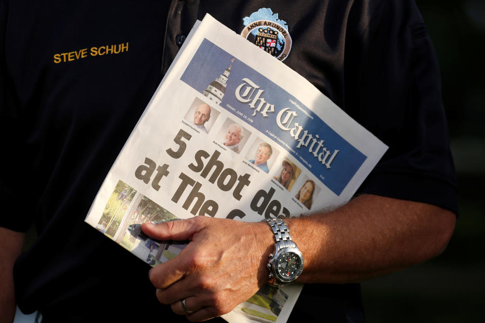 <p>Steve Schuh, the County Executive of Anne Arundel County, Maryland, holds a copy of the Capital Gazette as he is interviewed the day after a gunman killed five people and injured several others at the newspaper’s offices, in Annapolis, Md., June 29, 2018. (Photo: Joshua Roberts/Reuters) </p>