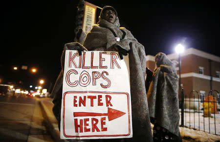 A demonstrator yells during a protest over the shooting death of Michael Brown in front of the Ferguson Police Department in Ferguson, Missouri, November 17, 2014. REUTERS/Jim Young