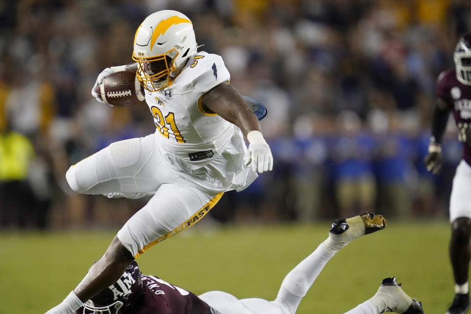 Kent State running back Bryan Bradford (31) leaps over Texas A&M defensive back Leon O'Neal Jr. (9) for a first down during the first half of an NCAA college football game on Saturday, Sept. 4, 2021, in College Station, Texas. (AP Photo/Sam Craft)