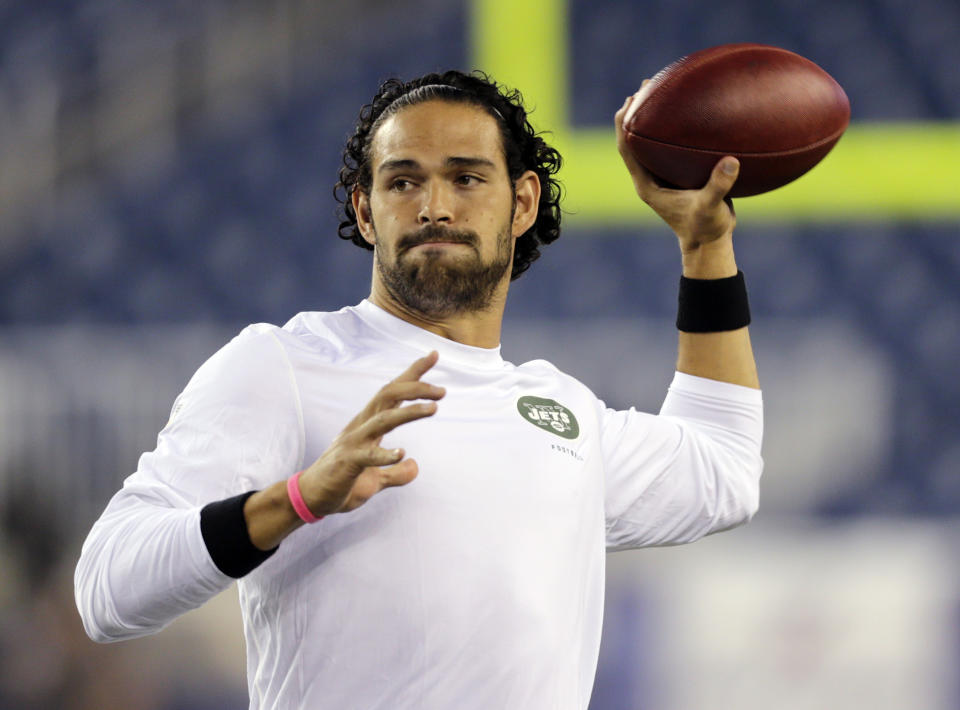 FILE - In a Sept. 12, 2013 filel photo, New York Jets quarterback Mark Sanchez, who normally throws right-handed, throws a pass with his left hang before an NFL football between the New England Patriots and the Jets game, in Foxborough. The New York Jets released Sanchez signed quarterback Michael Vick on Friday, March 21, 2014. Sanchez spent this past season on injured reserve after injuring his right shoulder in a preseason game. (AP Photo/Charles Krupa, File)