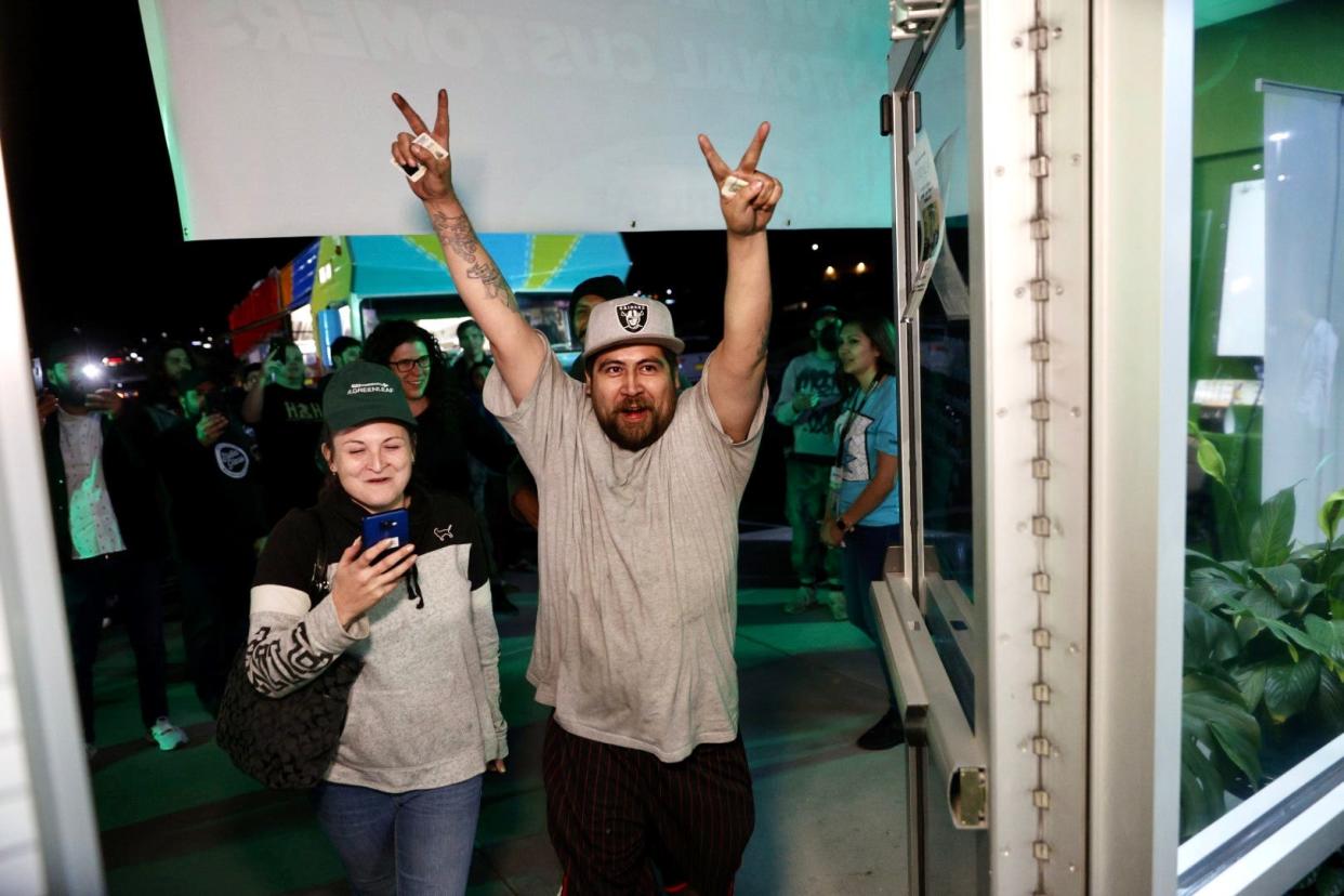 R. Greenleaf Dispensary customers enter the Las Cruces store just after 12:01 a.m. April 1, 2022, the first day of legal recreational cannabis sales in New Mexico.