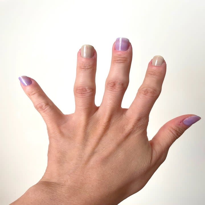 Back of hand showing purple and grey nail polish