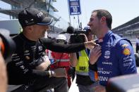 Tony Kanaan, left, of Brazil, talks with Alexander Rossi during qualifications for the Indianapolis 500 auto race at Indianapolis Motor Speedway, Sunday, May 21, 2023, in Indianapolis. (AP Photo/Darron Cummings)