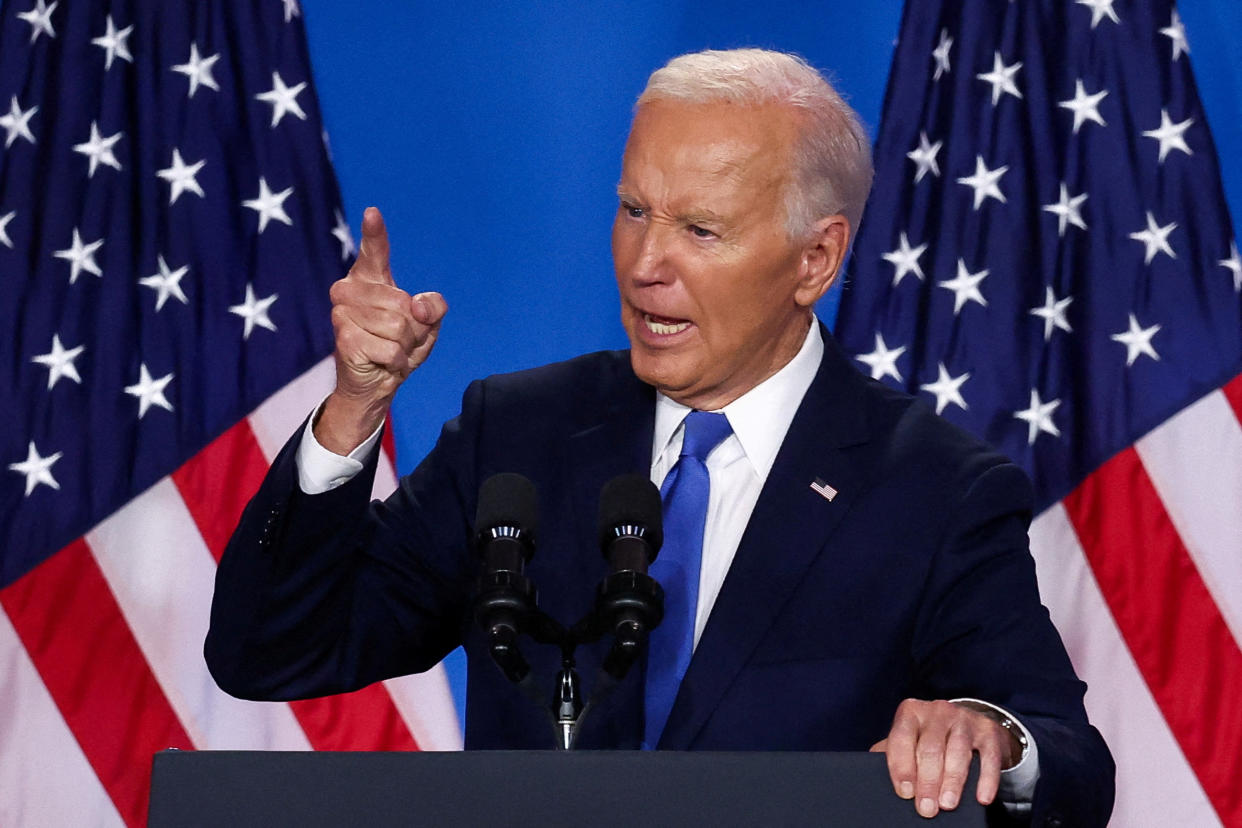 President Biden at podium in front of American flags.